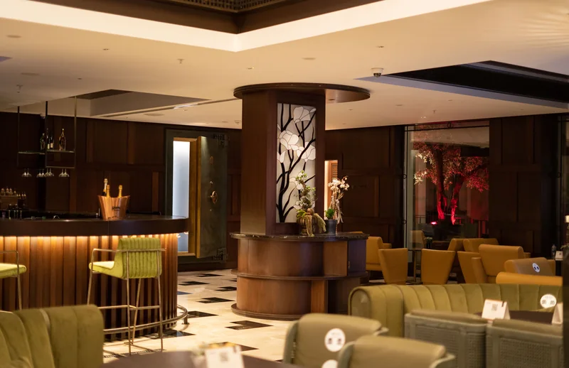 A quiet hotel lounge with warm lighting and comfortable seating.