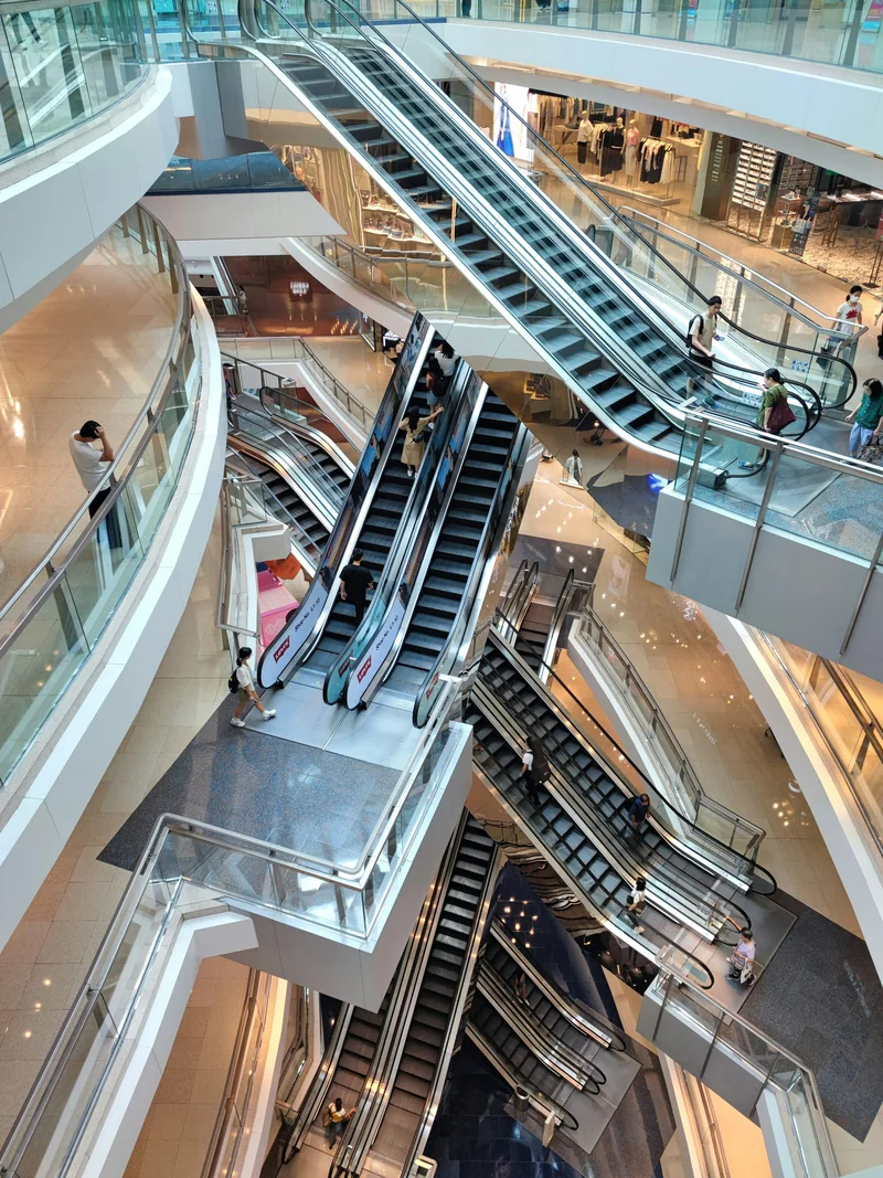 Escalators connect the floors of a modern shopping centre.